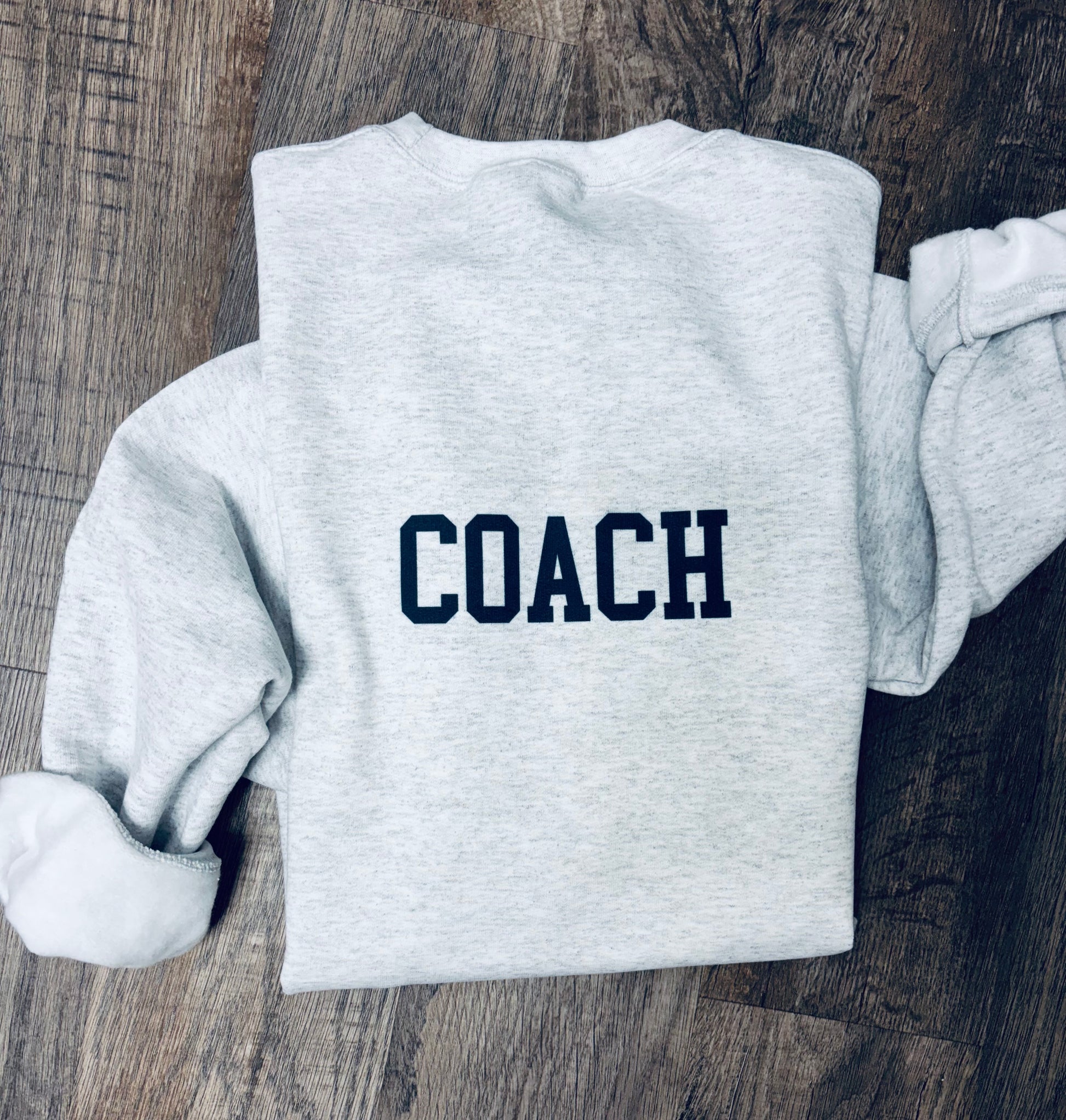 Custom cheer bow crewneck sweatshirt by Liv's Boutique, personalized team spirit wear, soft fabric, and comfortable fit.