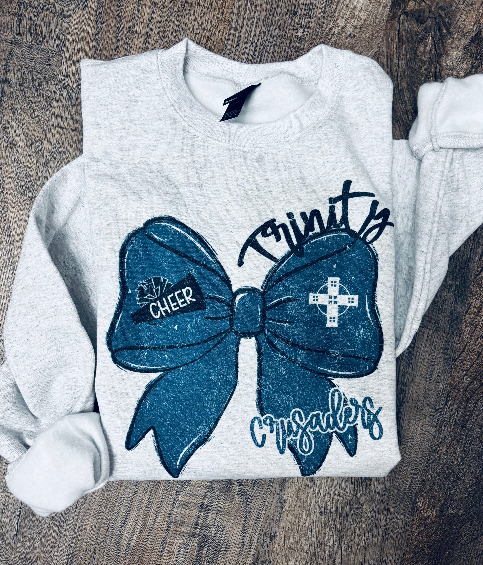 Custom cheer bow crewneck sweatshirt by Liv's Boutique featuring personalized team spirit design, soft fabric, and comfortable fit.